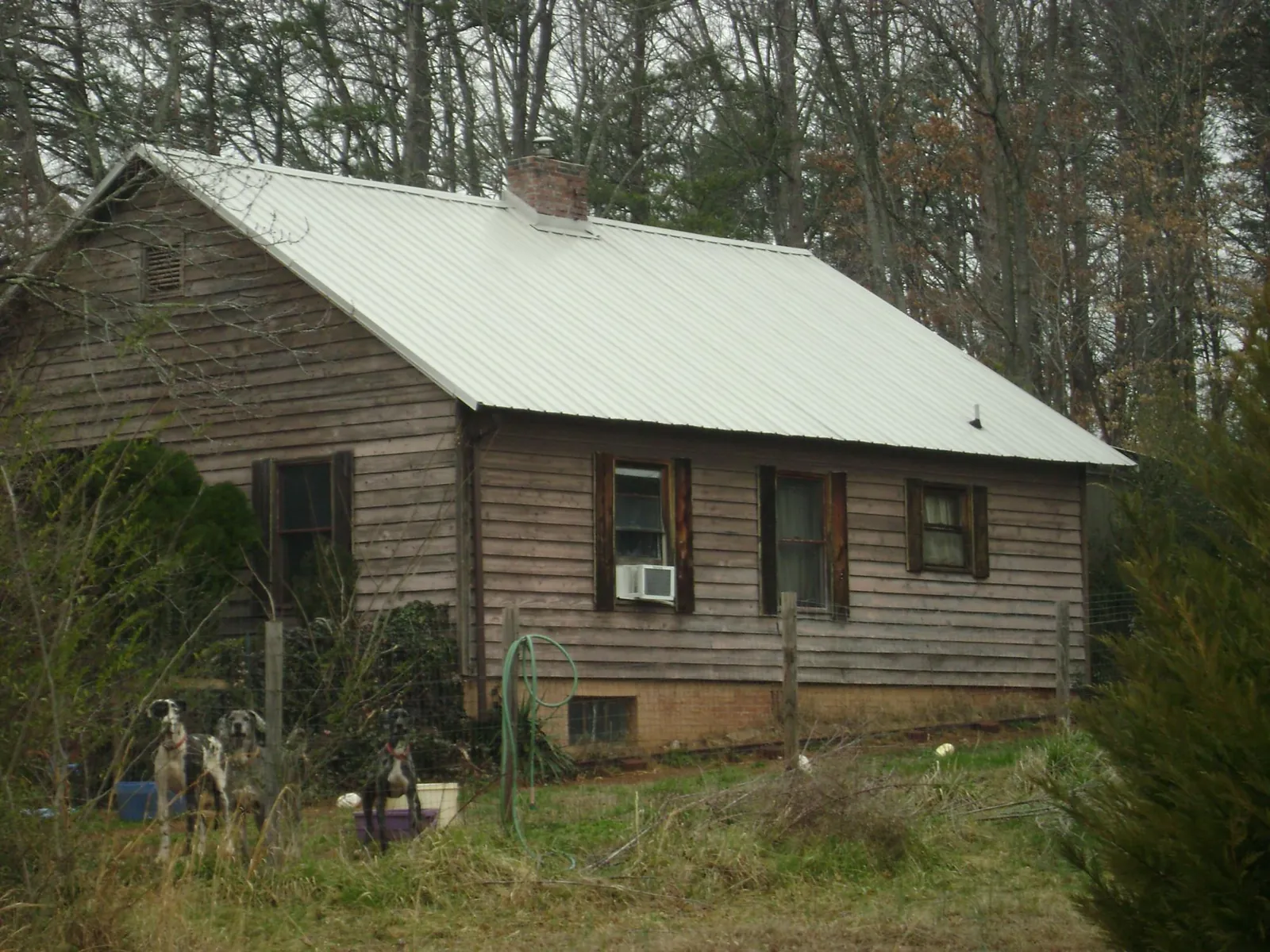 White metal roof on an old wood sided farmhouse, from a Metal Roof Installation job in Endicott
